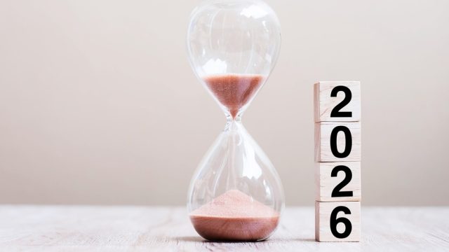 2026 text with hourglass on table.