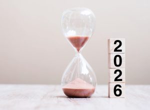 2026 text with hourglass on table.