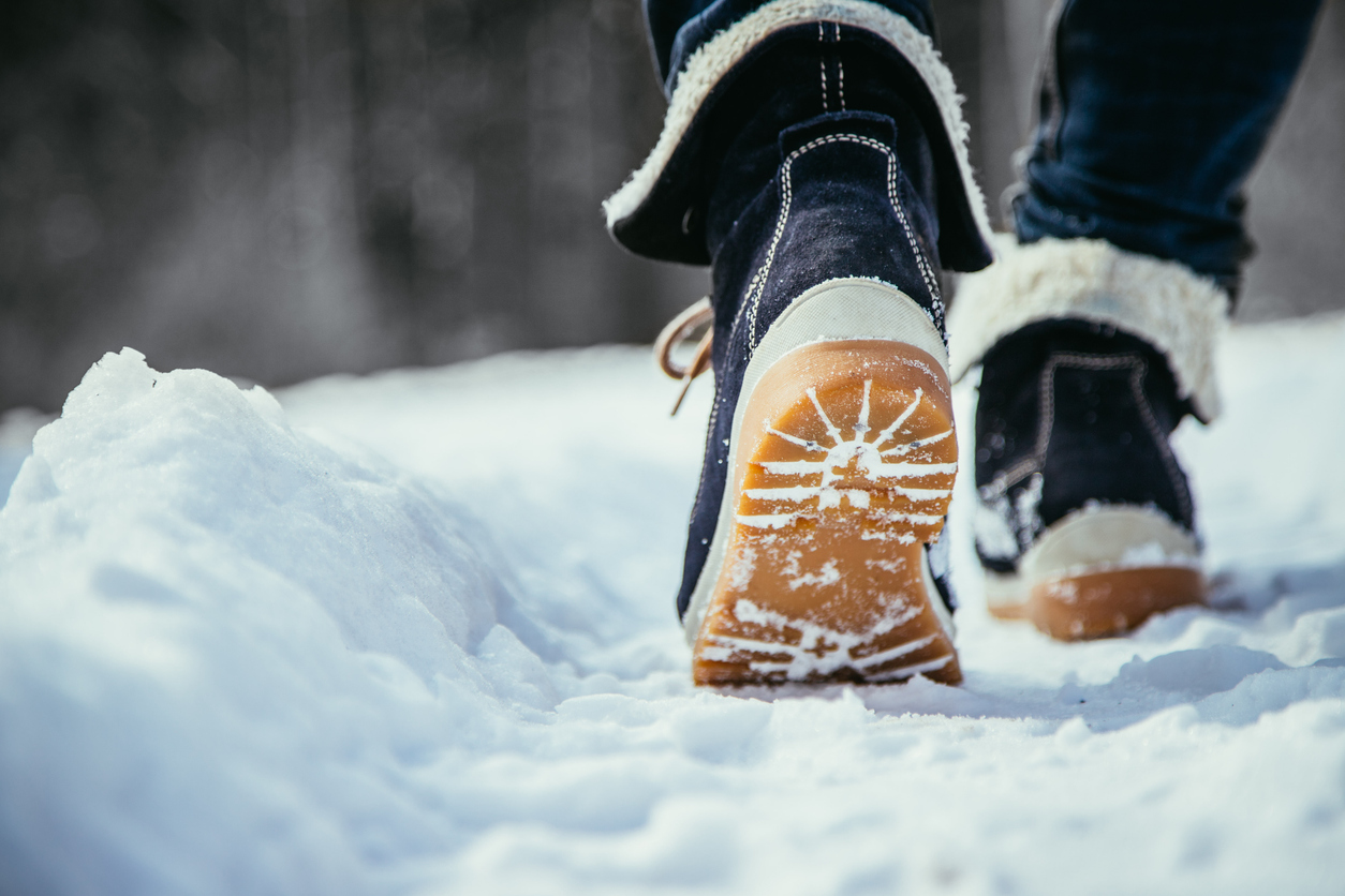 A pair of boots walking on snow
