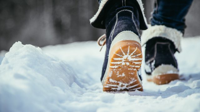 A pair of boots walking on snow