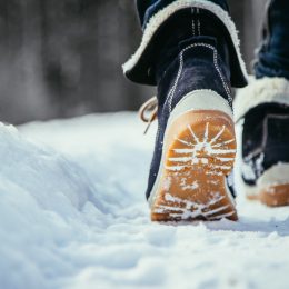 A pair of boots walking on snow
