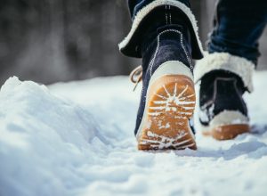 A pair of boots walking on snow