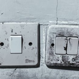 Old and Dirty Light Switches on a Worn Wall