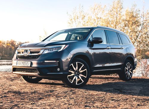Kyiv,Ukraine - October 2021: Honda Pilot Touring 2019 in a gary color near the river on a sunny day. Photoshoot