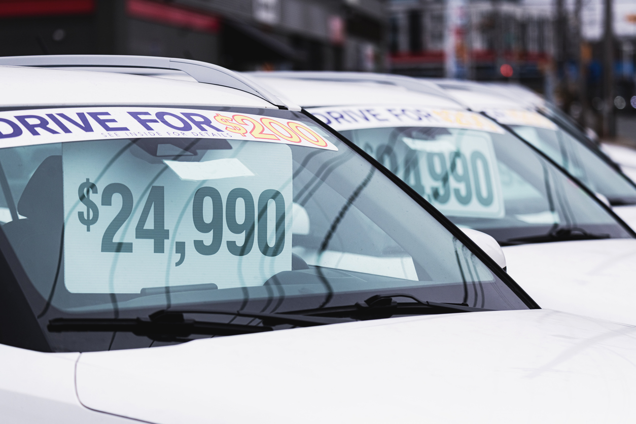 Price tags at a used car dealership.
