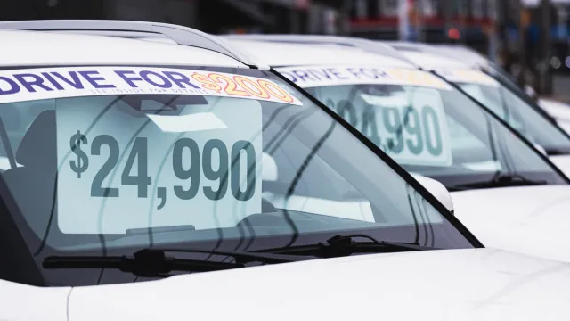 Price tags at a used car dealership.