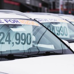 Price tags at a used car dealership.