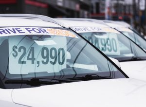 Price tags at a used car dealership.