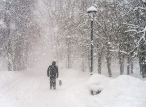 A man standing in a Christmas winter storm