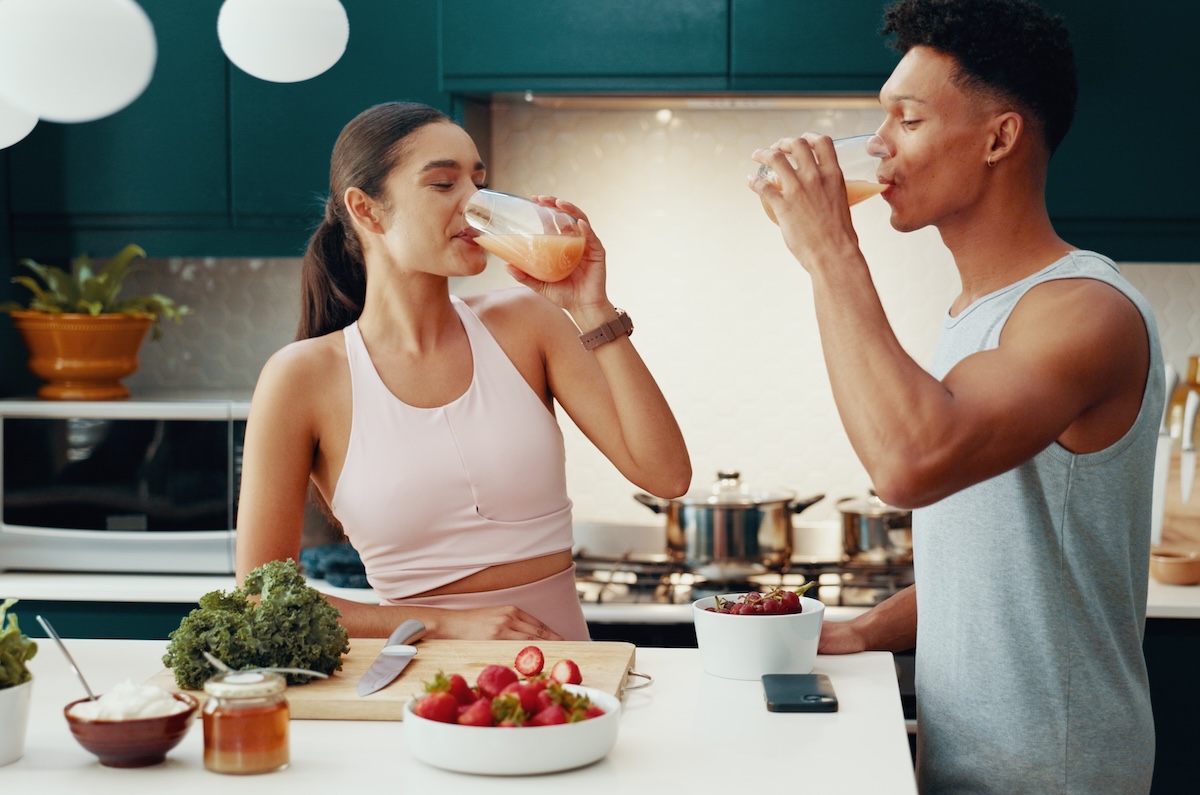 couple drinking smoothies in the kitchen