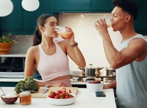 couple drinking smoothies in the kitchen
