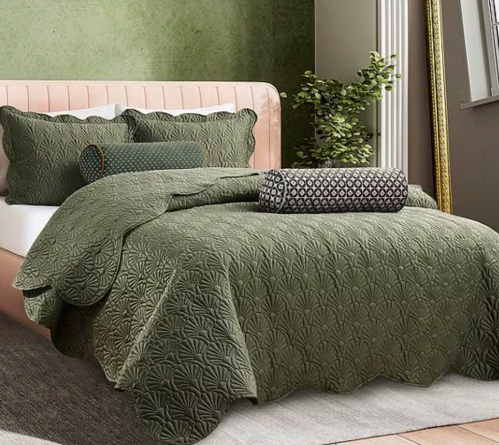 bed made up with a green quilt set