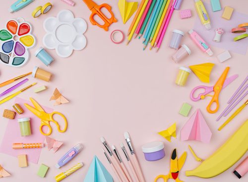Pink pastel background with various colorful material for creativity and art activity. Stationery and supplies for drawing and craft with 