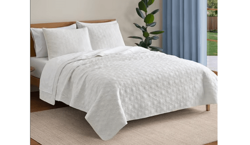 bed with white quilt