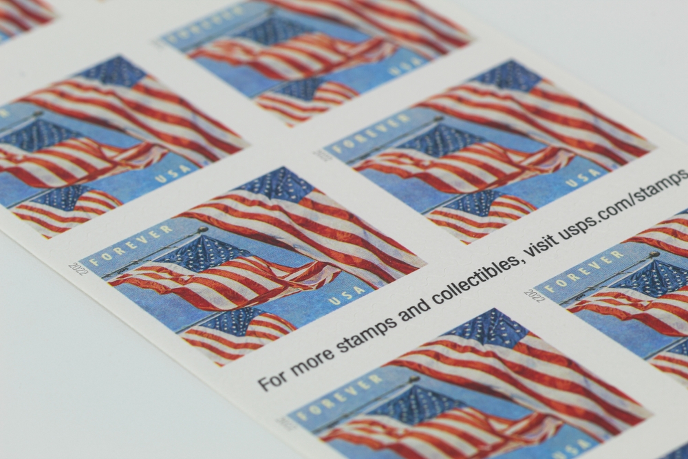 A close up of US flag postage stamps