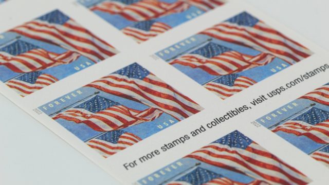 A close up of US flag postage stamps