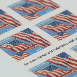 A close up of US flag postage stamps