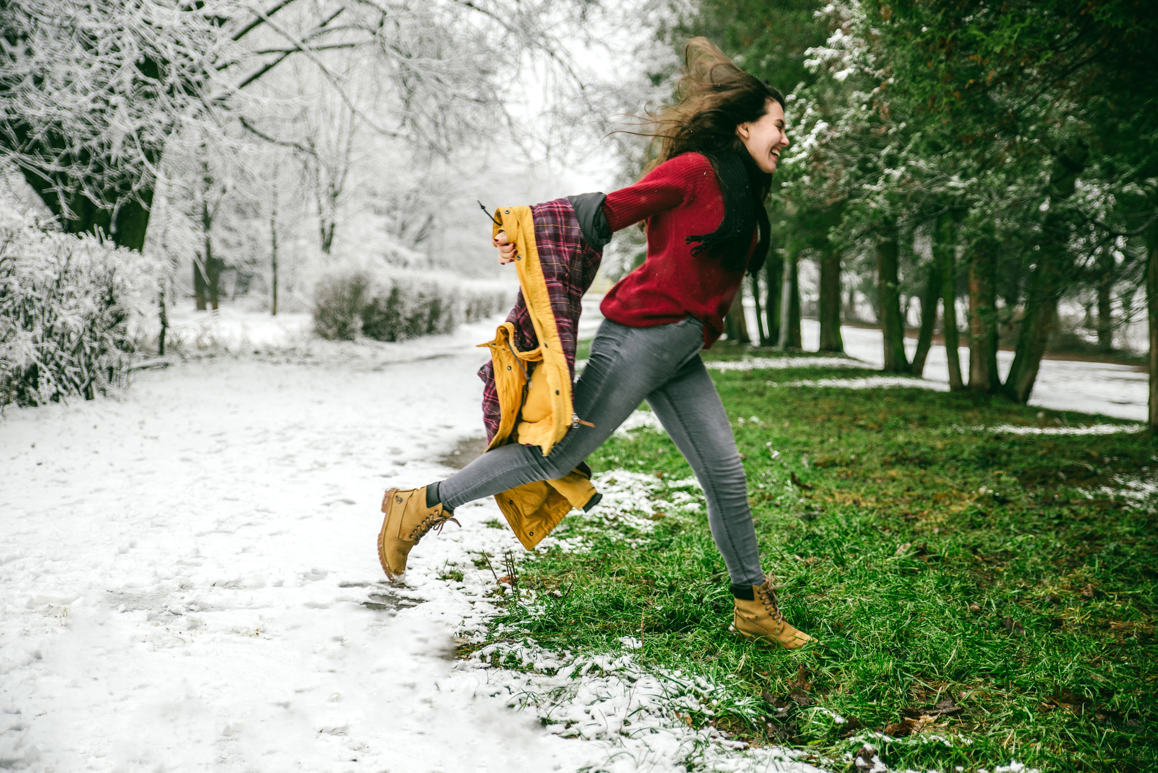 woman jumping from winter to spring