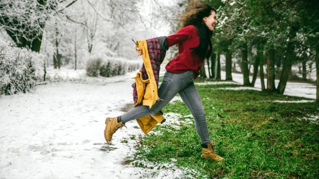 woman jumping from winter to spring