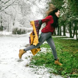 woman jumping from winter to spring