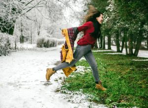 woman jumping from winter to spring