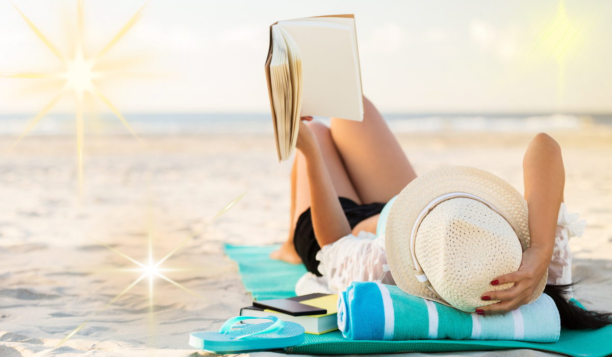 woman reading a book on the beach