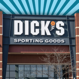 Dick's Sporting Goods store with a blue and gray striped background