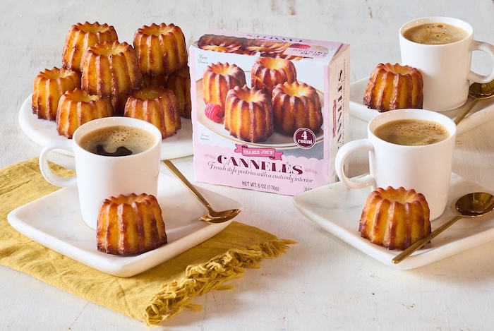 Trader Joe's Cannelés show stacked on a small marble platter; three espresso mugs and small plates, each with a Cannelé