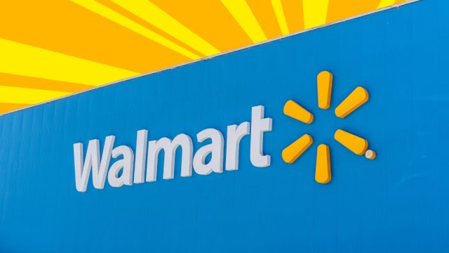 Closeup of a Walmart storefront with a yellow and orange background
