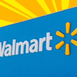 Closeup of a Walmart storefront with a yellow and orange background