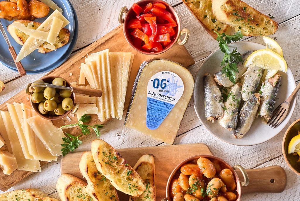 Trader Joe's The "OG" Aged Goat Cheese shown on tapas platter; with Giant Beans, olives, sardines, roasted red peppers and crostini