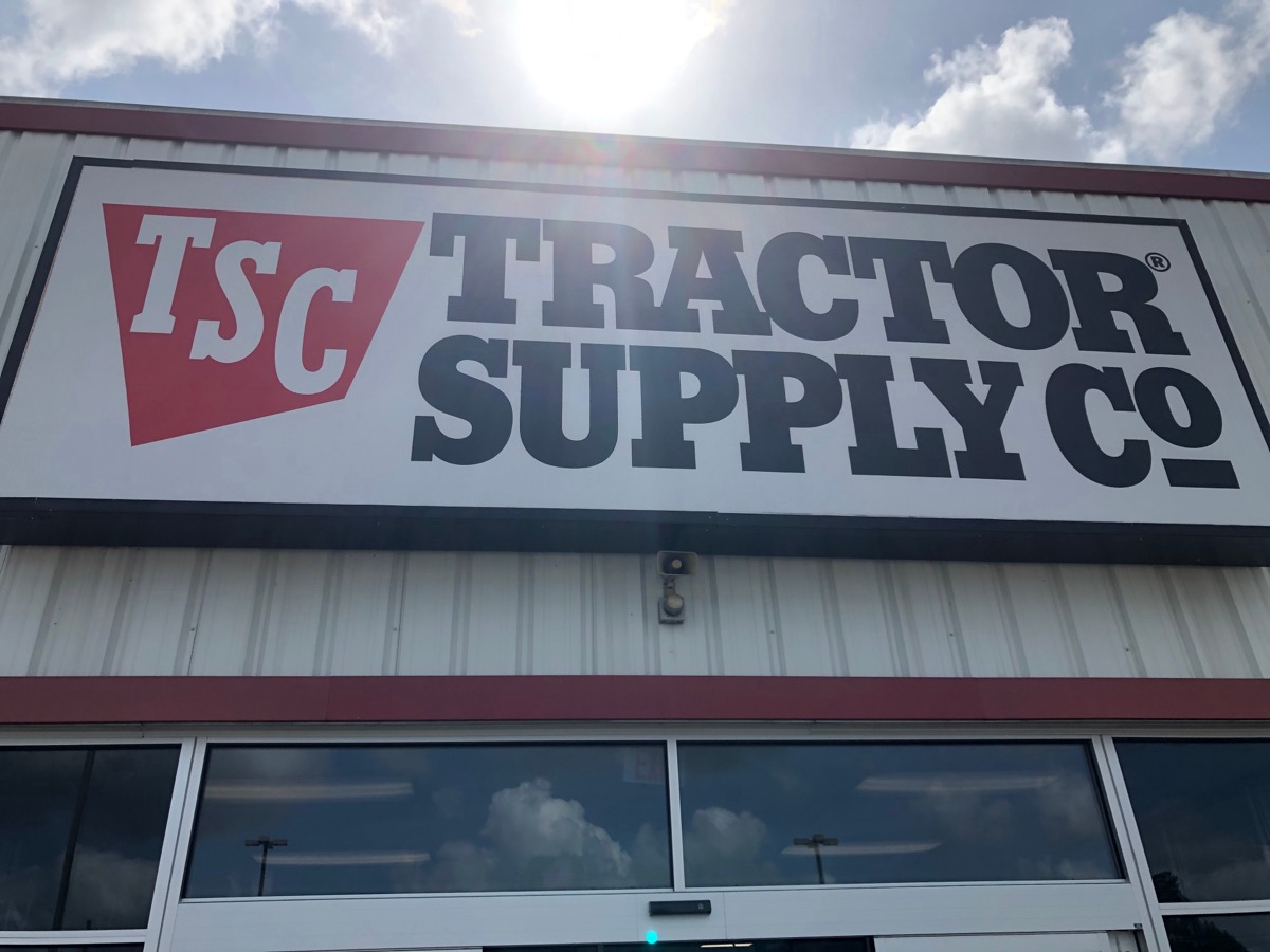 Tomball, TX /USA - May 23rd 2020: outside shot of the tractor supply co from a low angle with the sun above during current coronavirus lockdown.
