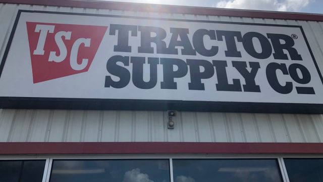 Tomball, TX /USA - May 23rd 2020: outside shot of the tractor supply co from a low angle with the sun above during current coronavirus lockdown.