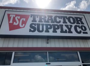 Tomball, TX /USA - May 23rd 2020: outside shot of the tractor supply co from a low angle with the sun above during current coronavirus lockdown.