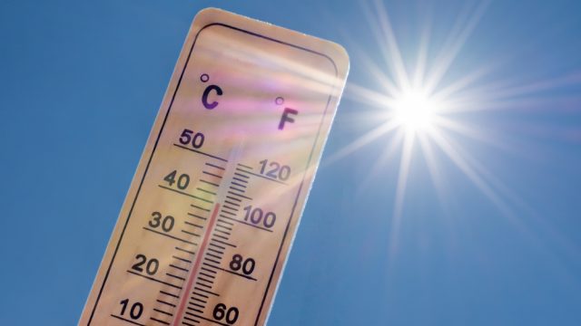 A thermometer displaying high temperatures in the sun
