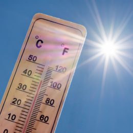 A thermometer displaying high temperatures in the sun
