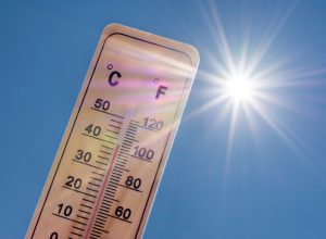 A thermometer displaying high temperatures in the sun