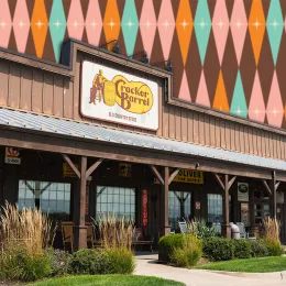 11 Best New Cracker Barrel Vintage and Nostalgic Decor Finds Under $15. Belton, Missouri - August 23, 2025: Sun shines on the front porch of a Cracker Barrel restaurant.