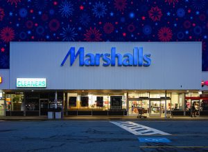 11 Best New Marshalls Finds Under $15 Hitting Shelves in July. Portsmouth, USA 09 26 2012: Outside building of Marshalls, an American off-price department store for clothes, apparel and homewares owned by TJX Companies at night with logo neon sign and parking lot