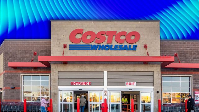 11 Costco Organization Finds a Professional Organizer Would Actually Approve Of. Calgary, Alberta, Canada. Mar 10, 2025. Costco Wholesale entrance with shoppers, carts, and signage. The building features brick and concrete with large glass doors and red accents.