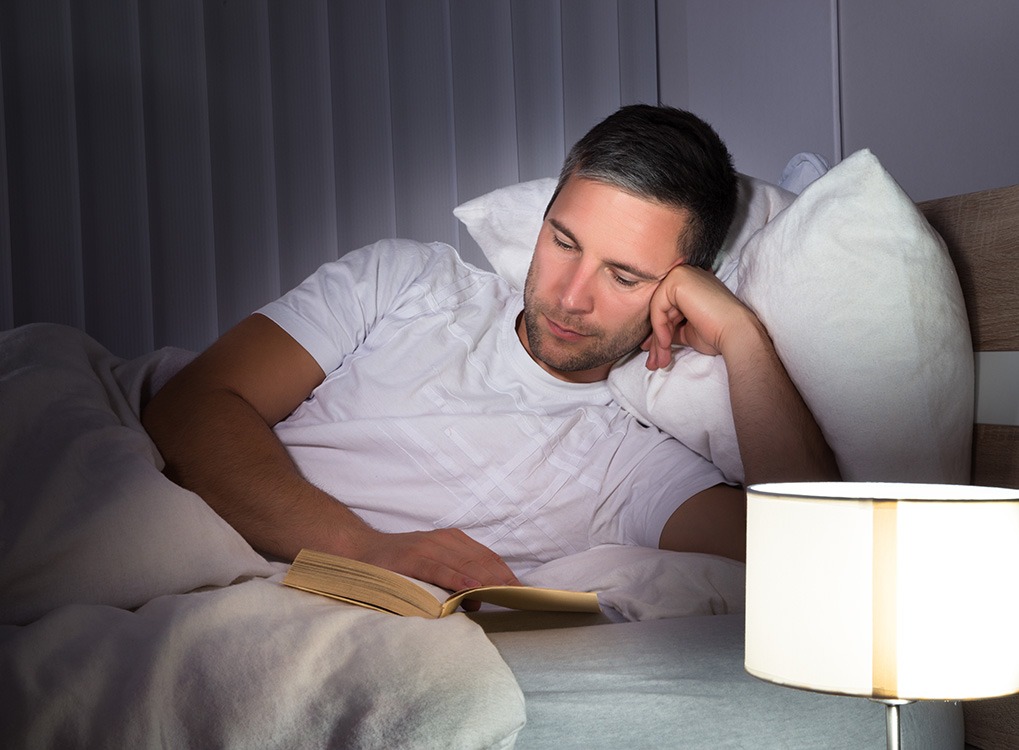 Man Reading Poems in Bed