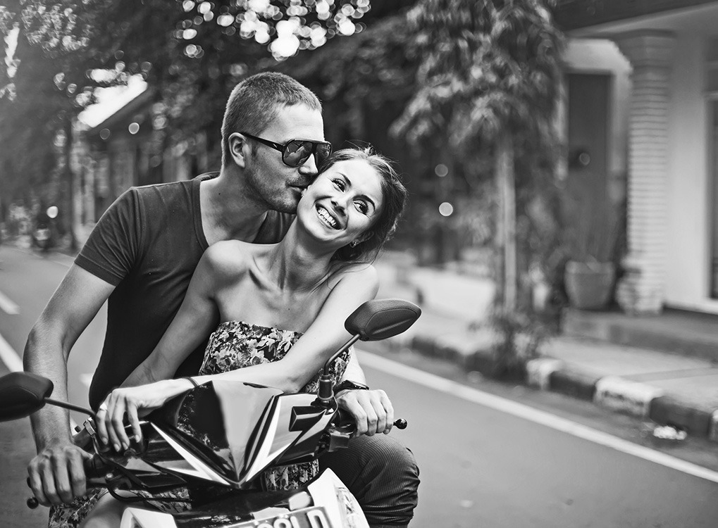 discounts couple on a motorcycle