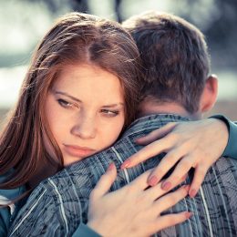 Unhappy couple hugging