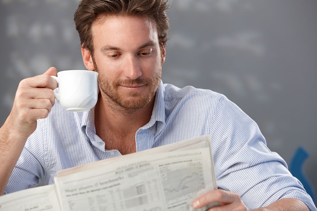 Man drinking coffee and easing into his morning, a great way to boost productivity. 