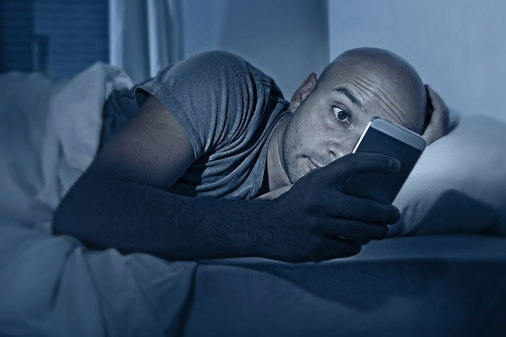 Man in Bed on Smartphone